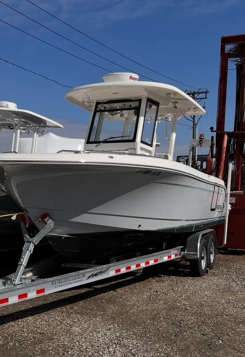 Slide: The Image of 2020 Robalo R272 Center Console boat on a trailer, ready for transport. - 17