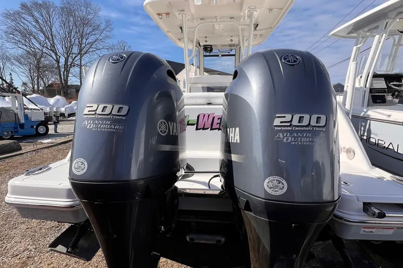 Slide: The Image of 2020 Robalo R272 Center Console with twin Yamaha 200 engines, docked outdoors. - 2