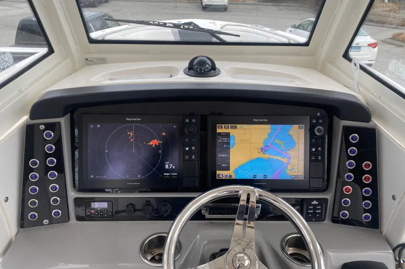 Slide: The Image of 2020 Robalo R272 Center Console dashboard with navigation screens and controls. - 36