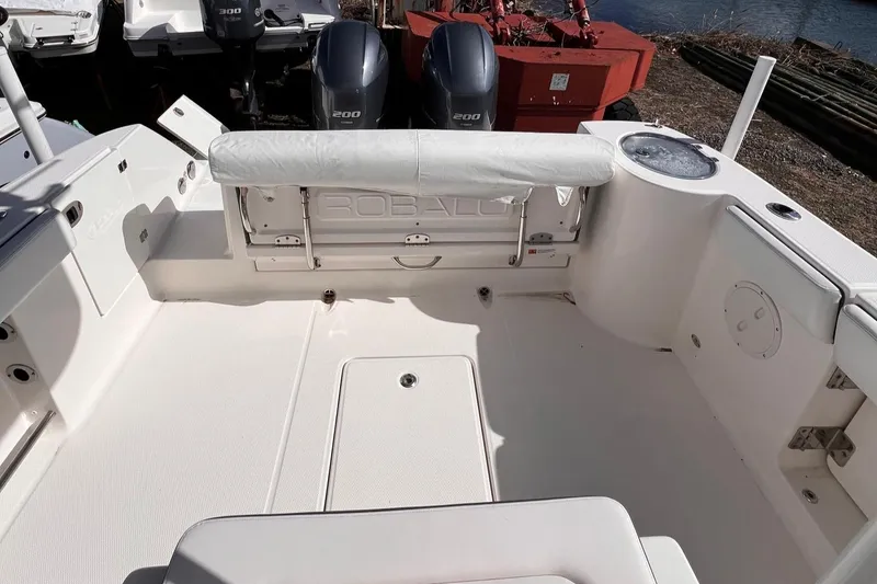 Slide: The Image of 2020 Robalo R272 Center Console boat interior with dual engines and seating area. - 5