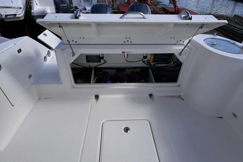 Slide: The Image of 2020 Robalo R272 Center Console boat with open storage compartment. - 7