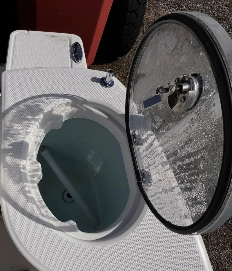 Slide: The Image of Open livewell on 2020 Robalo R272 Center Console boat, showcasing interior design. - 9