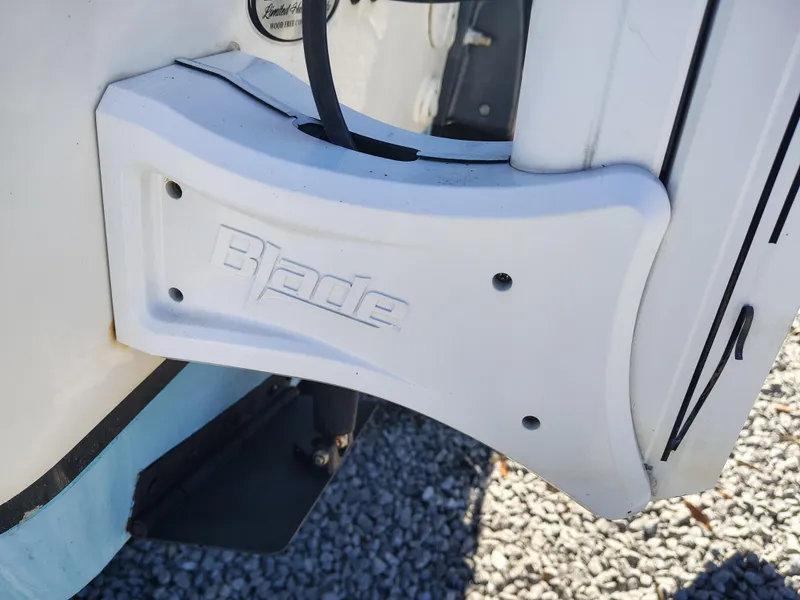 Slide: The Image of NauticStar 2302 Legacy 2021 boat with Blade mount detail, on gravel surface. - 20