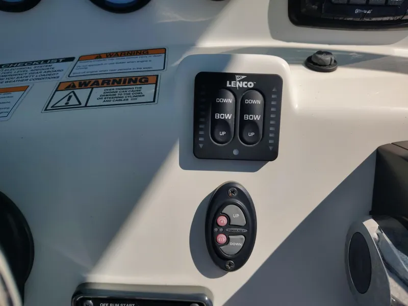 Slide: The Image of Control panel of 2021 NauticStar 2302 Legacy boat with Lenco trim tab switches. - 22