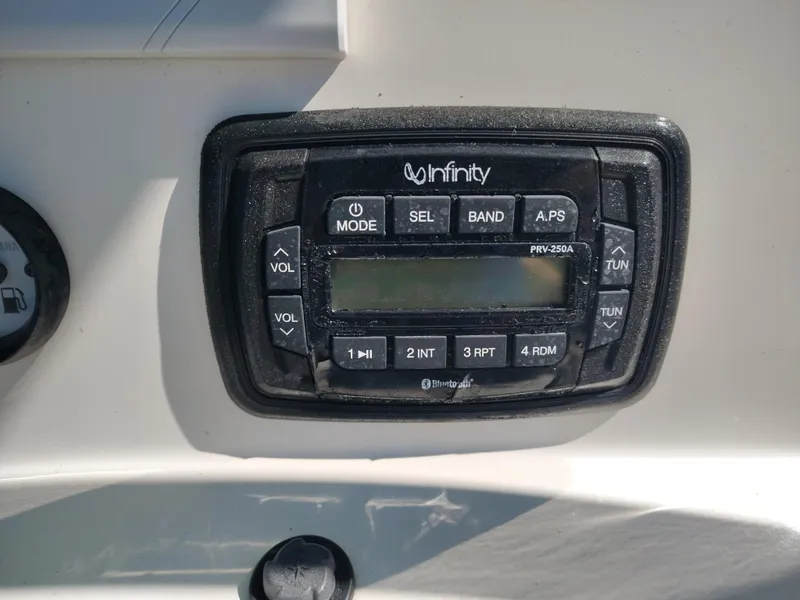 Slide: The Image of Infinity stereo system on a 2021 NauticStar 2302 Legacy boat dashboard. - 23