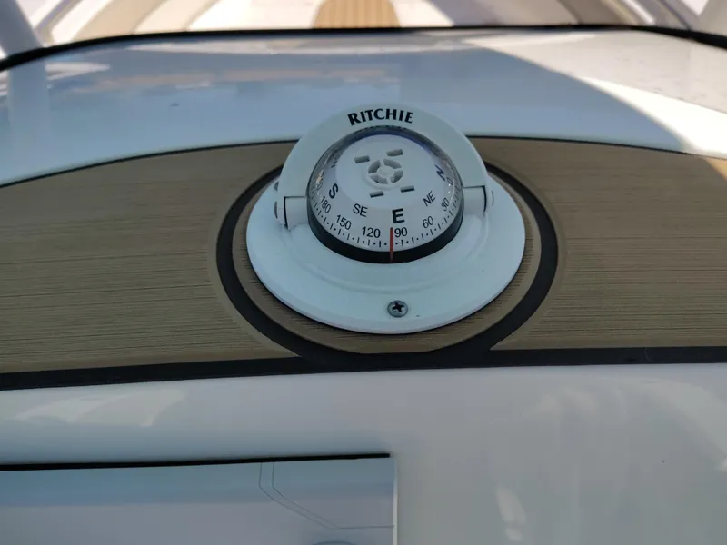 Slide: The Image of Compass on 2021 NauticStar 2302 Legacy boat dashboard. - 27