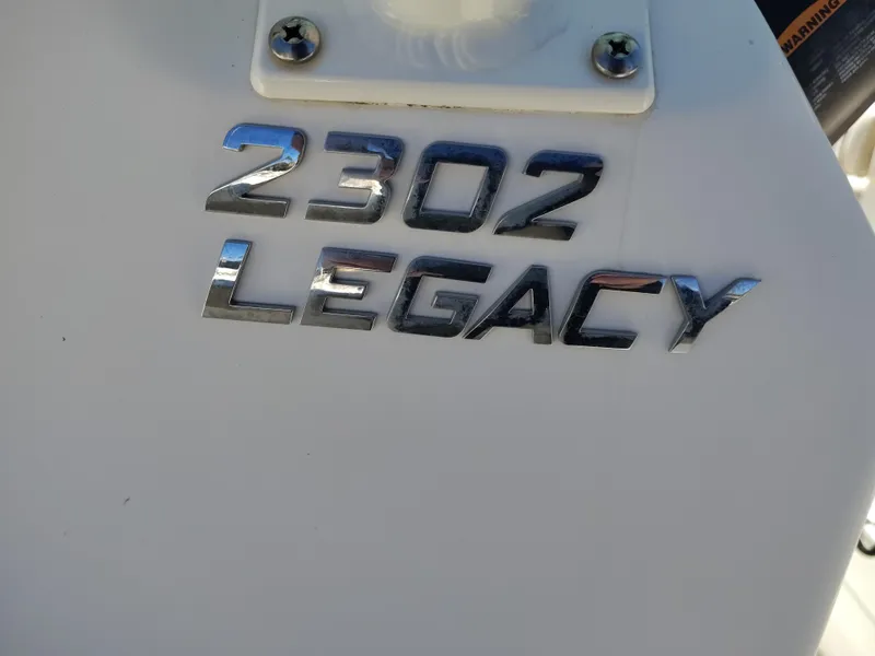 Slide: The Image of 2021 NauticStar 2302 Legacy boat model emblem in chrome finish. - 29