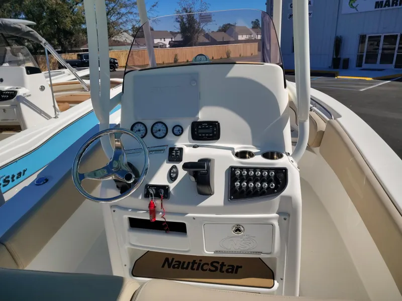 Slide: The Image of 2021 NauticStar 2302 Legacy boat console with steering wheel and controls. - 3