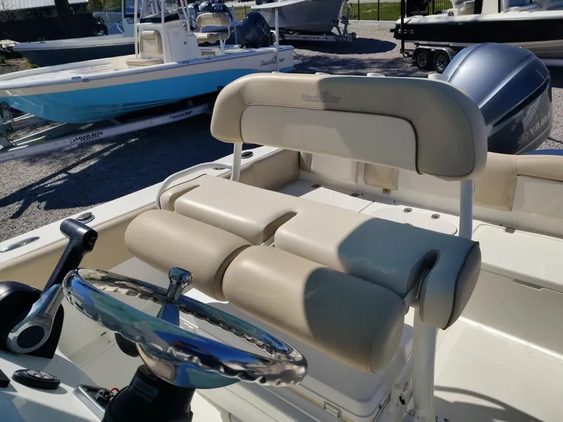 Slide: The Image of 2021 NauticStar 2302 Legacy boat interior with steering wheel and seating. - 32