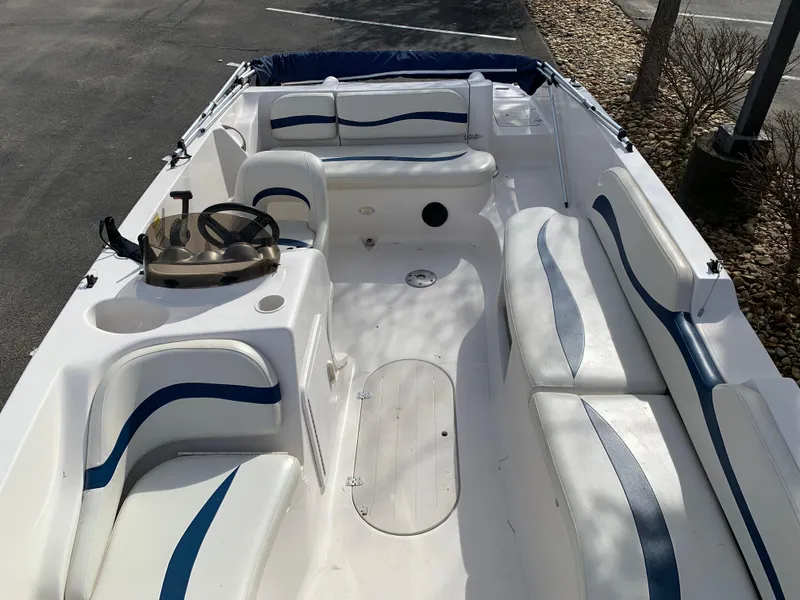 Slide: The Image of 2006 Starcraft SeaStar 2000 boat interior with white and blue seating, steering wheel, and open deck. - 3