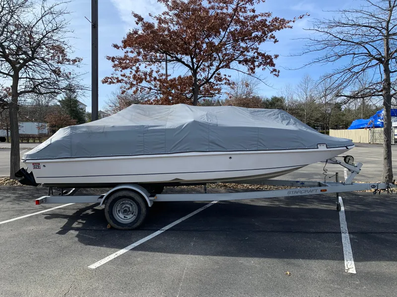 Slide: The Image of Covered 2006 Starcraft SeaStar 2000 boat on trailer in parking lot. - 9