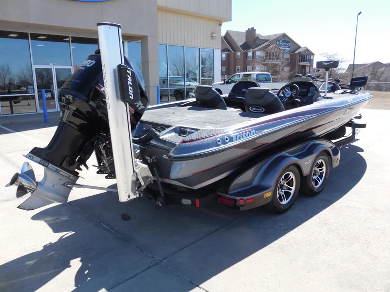 Slide: The Image of 2013 Triton 21XS DC boat on trailer, parked outside a building. - 3