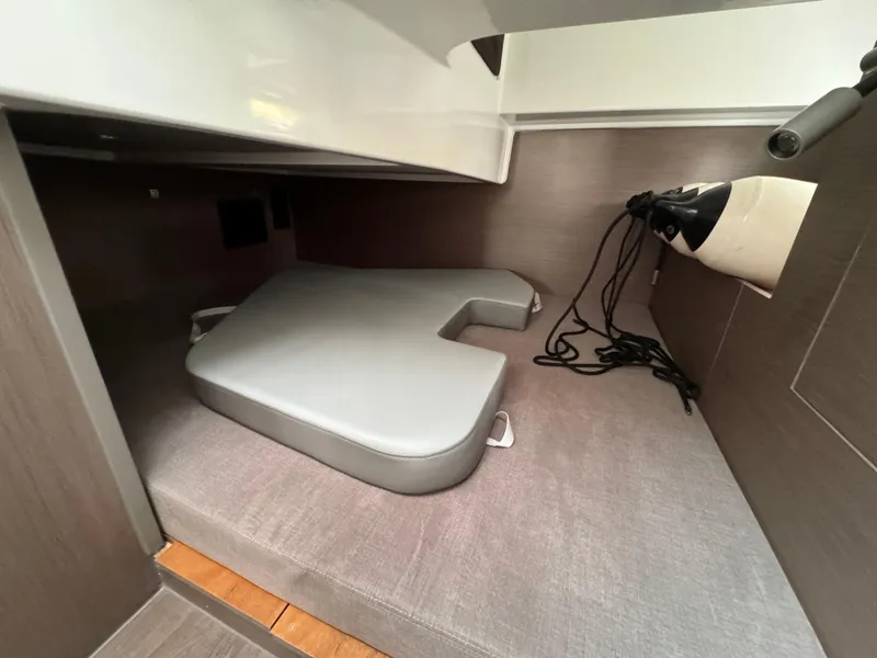 Slide: The Image of 2024 Beneteau Gran Turismo 32 interior cabin with cushions and storage space. - 16
