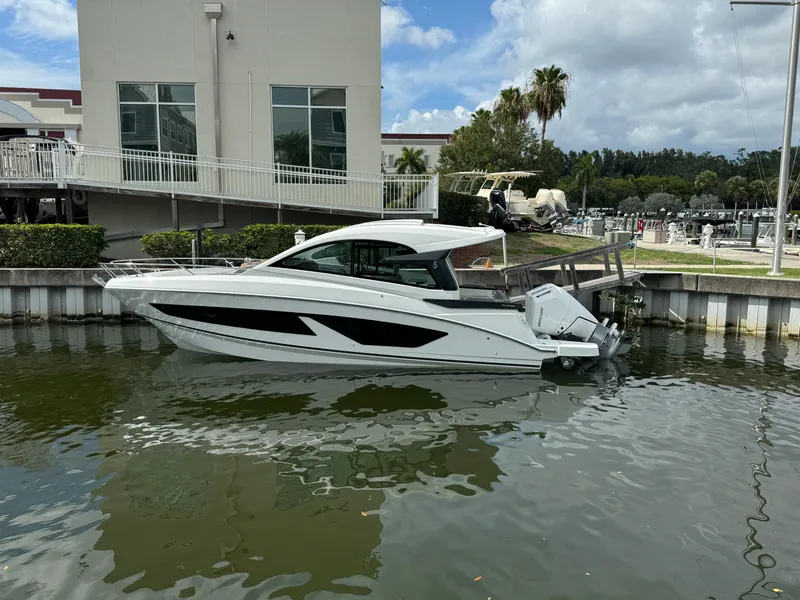 Slide: The Image of 2024 Beneteau Gran Turismo 32 yacht docked in marina, sleek design, calm water. - 2