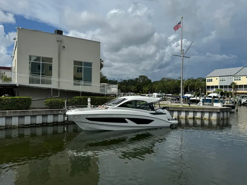 Slide: The Image of 2024 Beneteau Gran Turismo 32 yacht docked at marina under cloudy sky. - 3