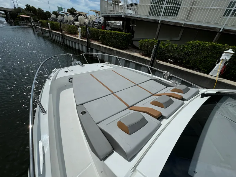 Slide: The Image of 2024 Beneteau Gran Turismo 32 yacht with spacious sunbathing deck by a canal. - 4