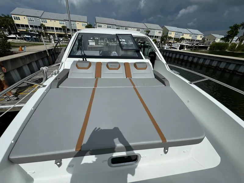 Slide: The Image of 2024 Beneteau Gran Turismo 32 yacht with sleek deck design, docked in a marina. - 5