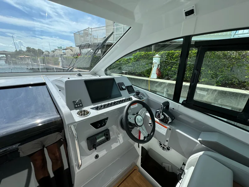 Slide: The Image of 2024 Beneteau Gran Turismo 32 helm with modern controls and navigation system. - 7
