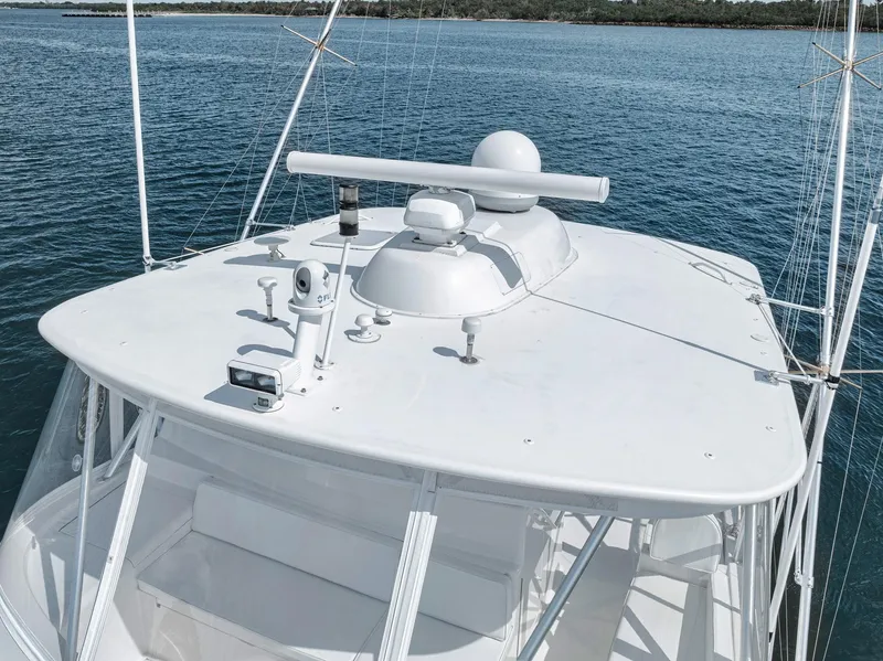 Slide: The Image of 2009 Viking 54 Convertible yacht on calm blue water, showcasing radar and navigation equipment. - 21