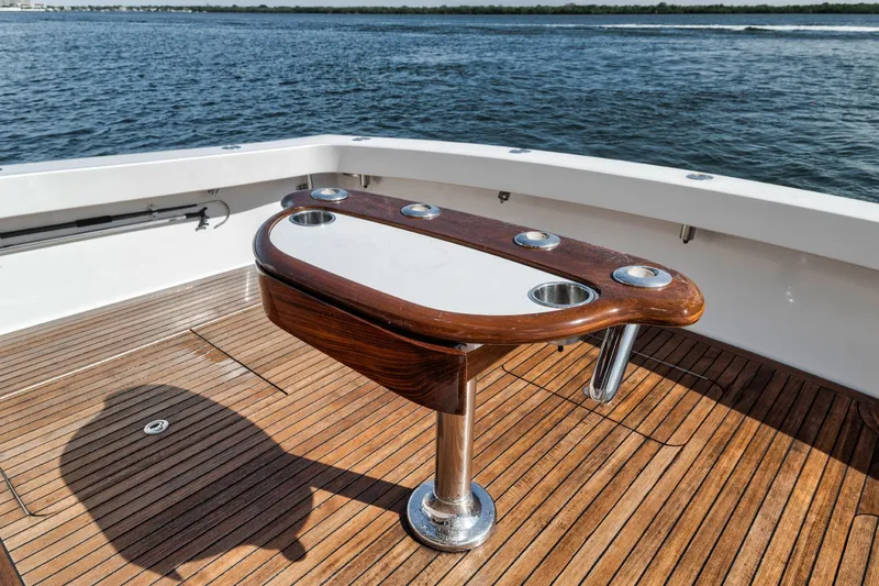 Slide: The Image of 2009 Viking 54 Convertible yacht deck with wooden table, ocean view. - 25