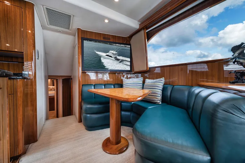 Slide: The Image of Luxurious interior of 2009 Viking 54 Convertible yacht with plush seating and wooden accents. - 36