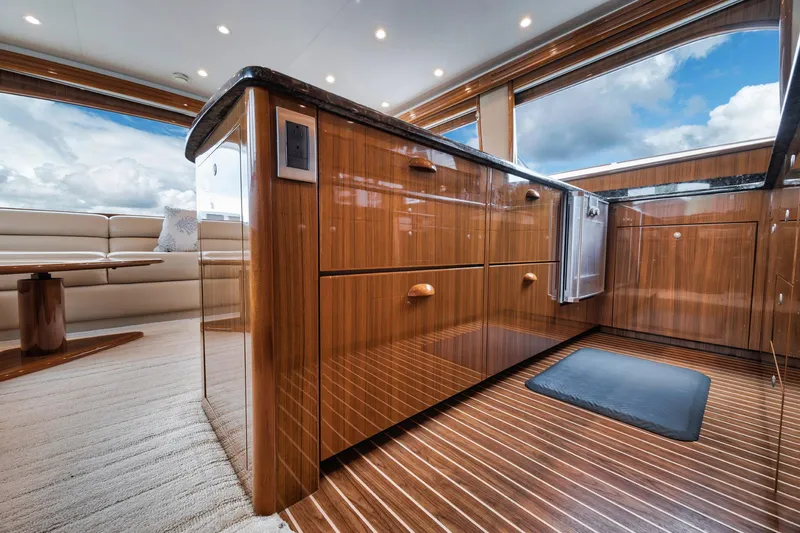 Slide: The Image of Luxurious interior of 2009 Viking 54 Convertible yacht with polished wood cabinetry and panoramic windows. - 37