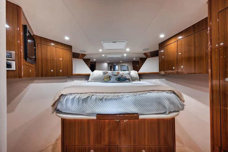 Slide: The Image of Luxurious bedroom interior of 2009 Viking 54 Convertible yacht with wood paneling. - 42