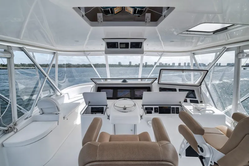 Slide: The Image of 2009 Viking 54 Convertible yacht helm with panoramic ocean view and modern controls. - 46