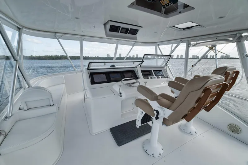 Slide: The Image of 2009 Viking 54 Convertible yacht helm with leather seats and panoramic water view. - 48