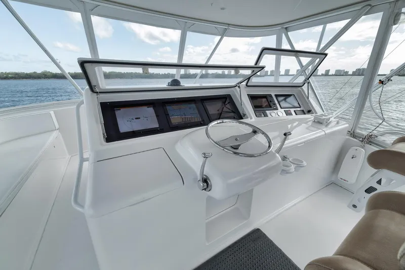 Slide: The Image of 2009 Viking 54 Convertible yacht helm with modern navigation equipment and ocean view. - 49