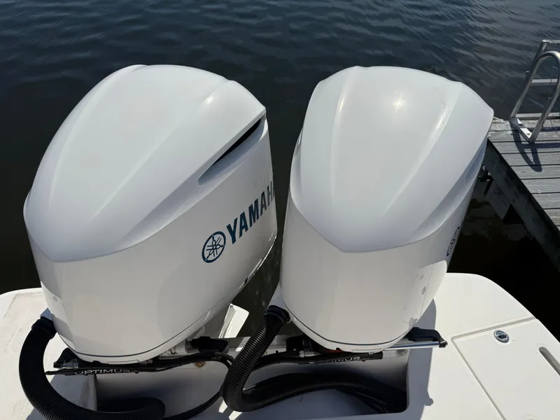 Slide: The Image of Twin Yamaha outboard engines on a 2020 Regal 29 OBX boat by the water. - 43