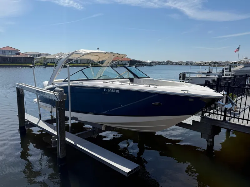 The Image of 2020 Regal 29 OBX boat docked on a sunny day by the water. - 0