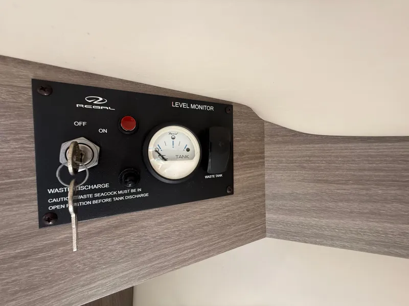Slide: The Image of Level monitor panel on 2020 Regal 29 OBX boat, waste discharge controls. - 40
