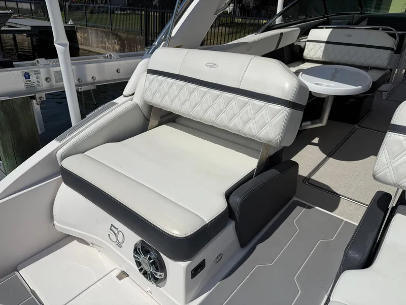 Slide: The Image of 2020 Regal 29 OBX boat interior with white seating and speaker. - 32