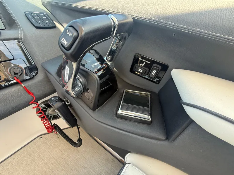 Slide: The Image of 2020 Regal 29 OBX boat control panel with throttle and switches. - 36