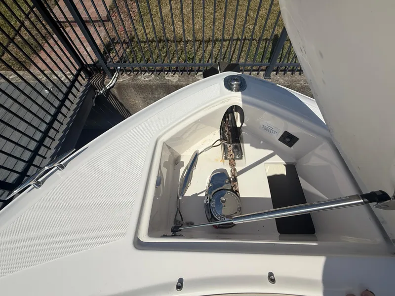 Slide: The Image of 2020 Regal 29 OBX boat anchor compartment with chain and winch. - 20
