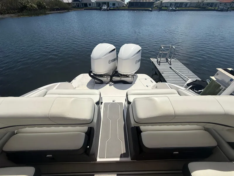 Slide: The Image of 2020 Regal 29 OBX boat with twin Yamaha outboard engines on a calm lake. - 29