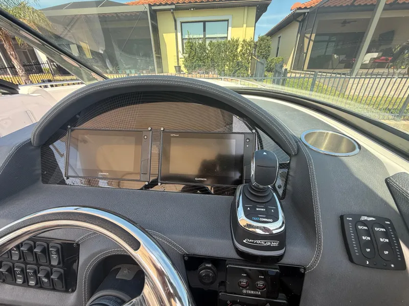 Slide: The Image of Dashboard of a 2020 Regal 29 OBX boat with modern controls and displays. - 35