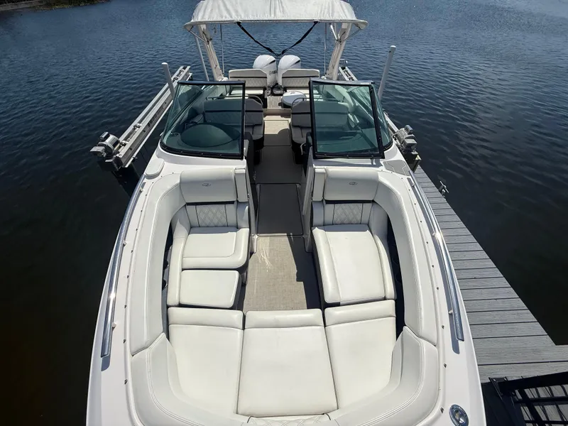 Slide: The Image of 2020 Regal 29 OBX boat with spacious seating, docked on calm water. - 13