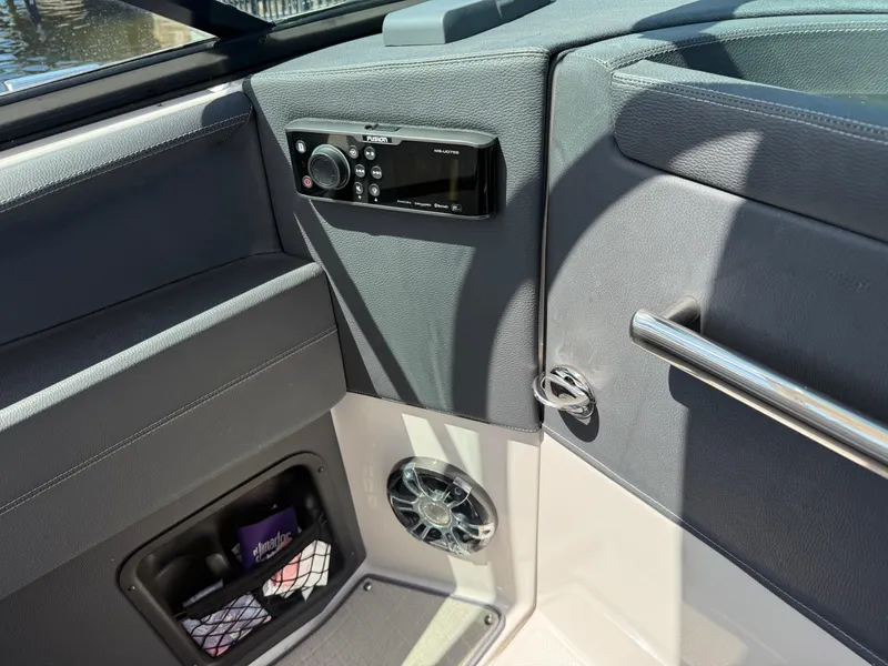 Slide: The Image of 2020 Regal 29 OBX boat interior with audio system and storage compartment. - 42