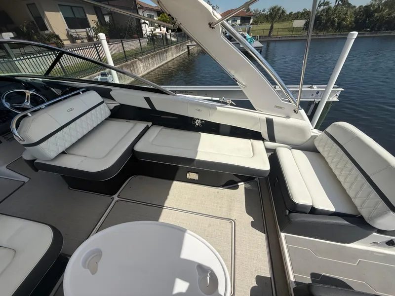 Slide: The Image of 2020 Regal 29 OBX boat interior with cushioned seating and water view. - 28