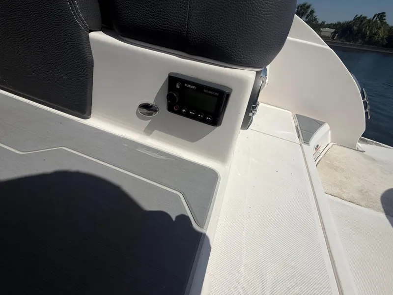 Slide: The Image of 2020 Regal 29 OBX boat interior with control panel and seating, near water. - 44