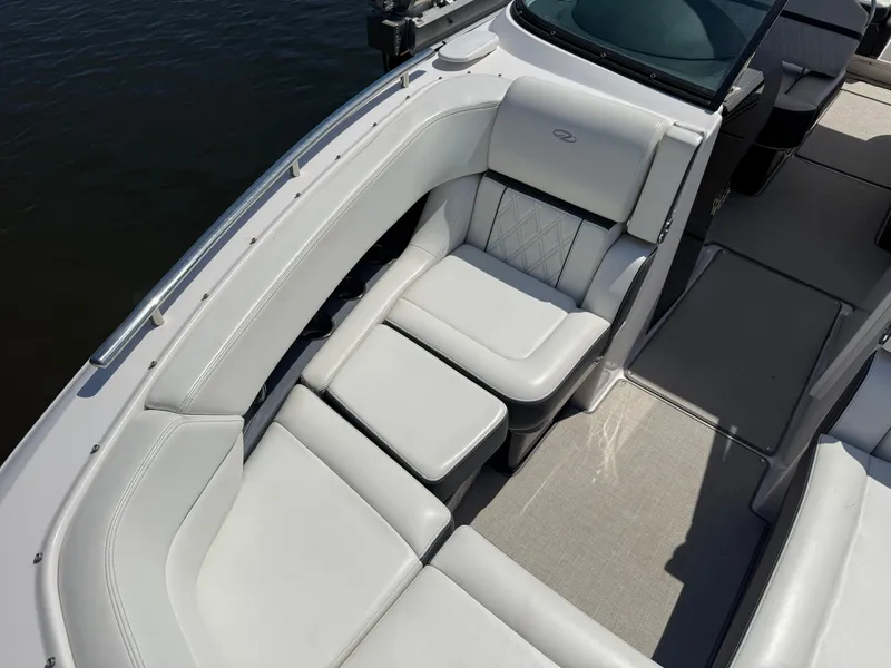 Slide: The Image of 2020 Regal 29 OBX boat interior with luxurious white seating and elegant design. - 14