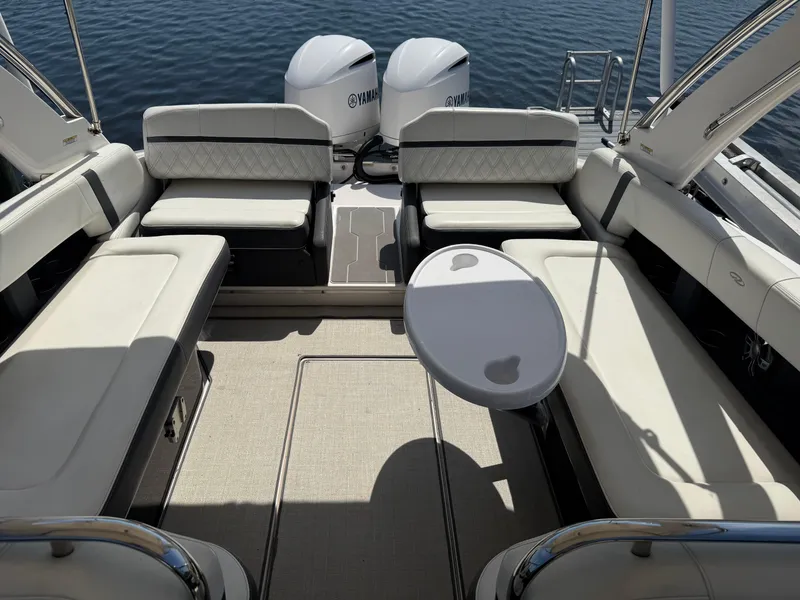 Slide: The Image of 2020 Regal 29 OBX boat interior with seating and table, featuring twin Yamaha engines. - 22