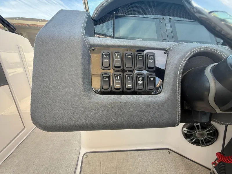 Slide: The Image of Dashboard controls of a 2020 Regal 29 OBX boat, featuring multiple switches. - 37