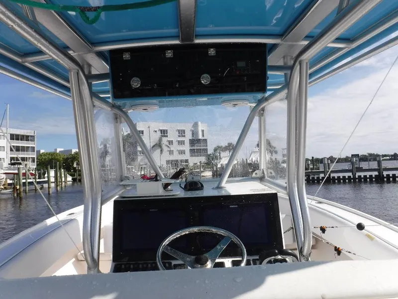 Slide: The Image of Cockpit view of 2017 Dusky 33 Tournament boat with marina backdrop. - 13