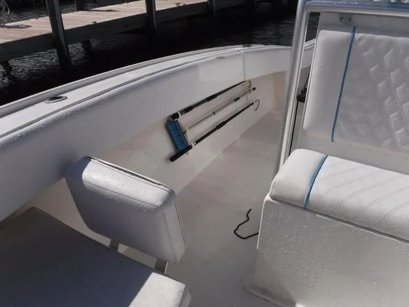 Slide: The Image of Interior of 2017 Dusky 33 Tournament boat with white seating and rod holders. - 15