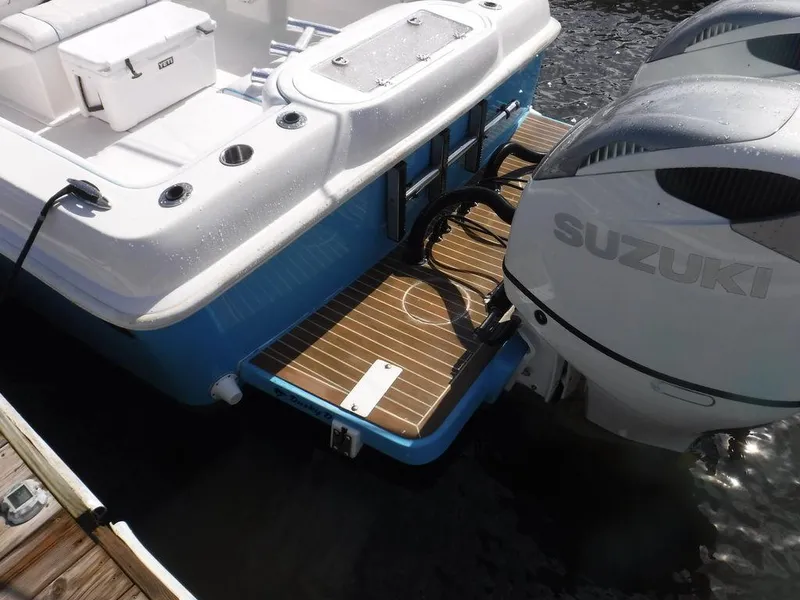 Slide: The Image of 2017 Dusky 33 Tournament boat with Suzuki outboard engine, docked on water. - 6