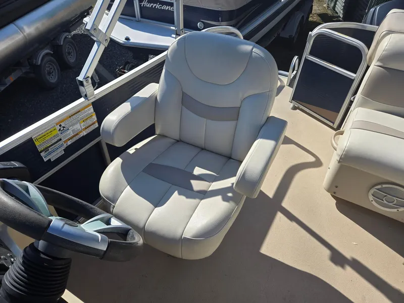 Slide: The Image of Captain's chair on 2014 Sweetwater 2086 boat, featuring comfortable seating and steering wheel. - 10