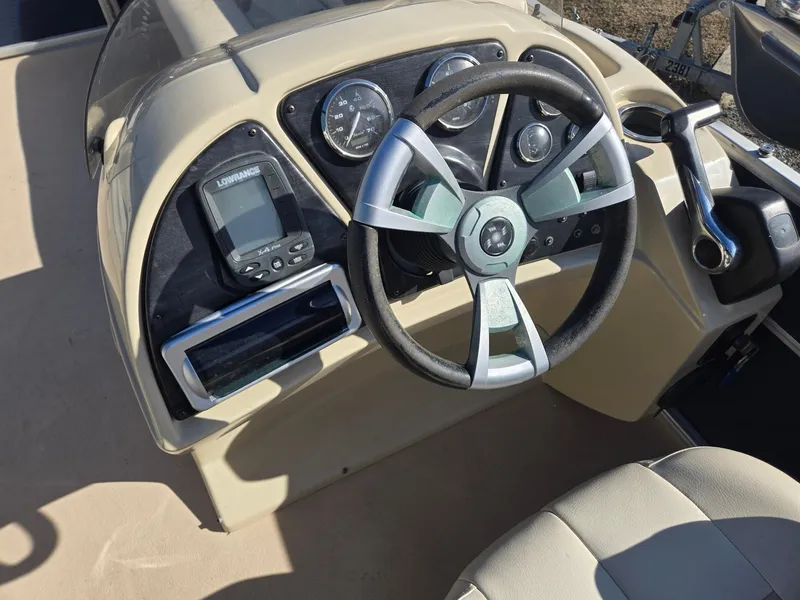 Slide: The Image of Steering console of a 2014 Sweetwater 2086 boat with gauges and controls. - 11